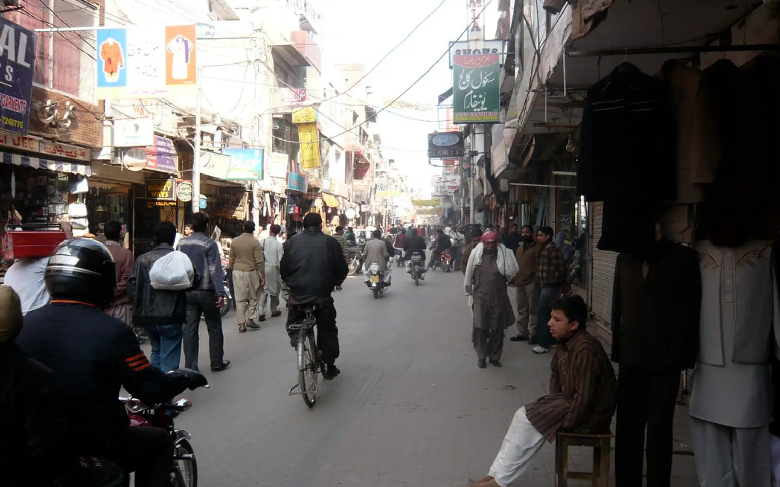 Shoppers and motorbikes in Anarkali market, Lahore