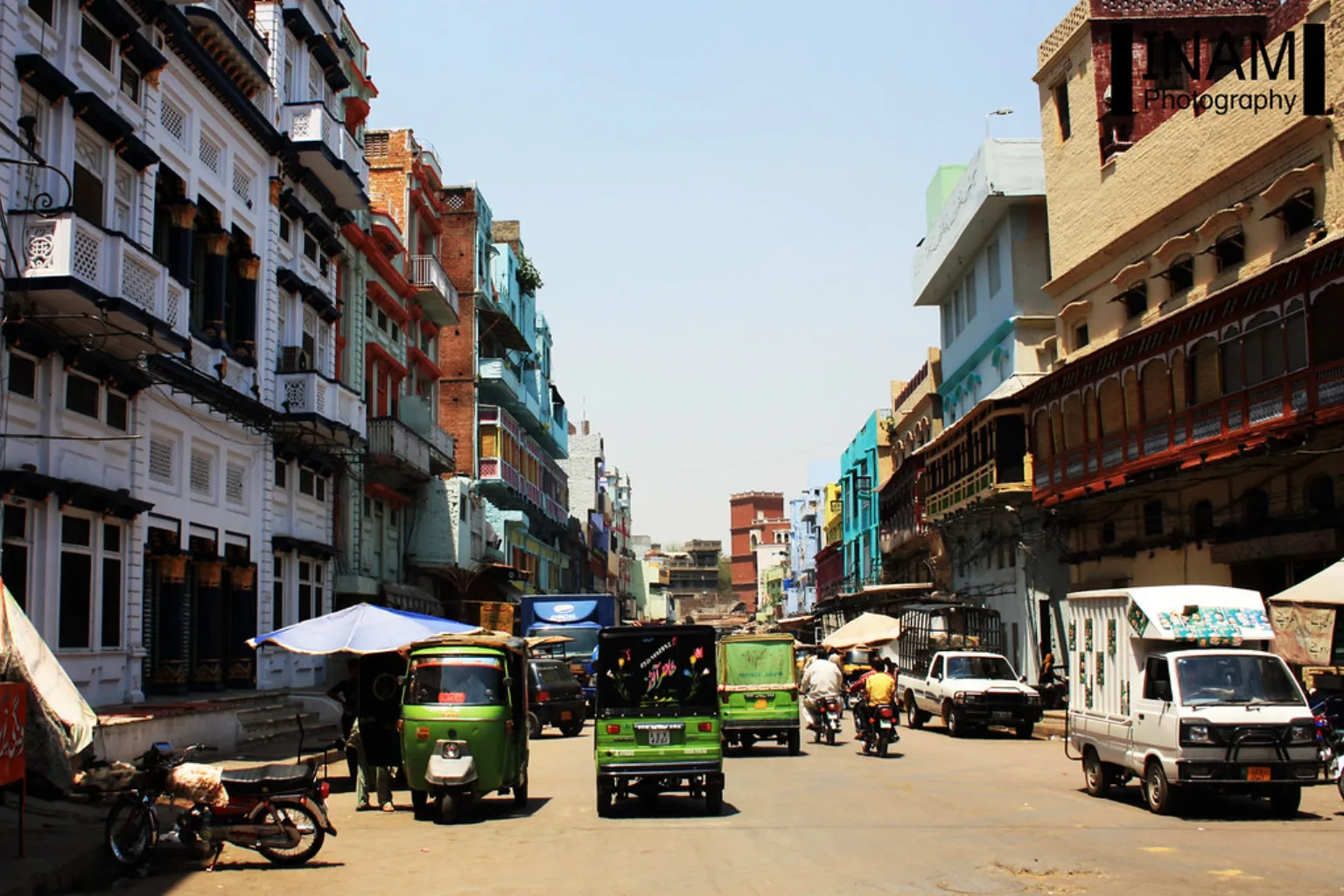 Rickshaws and traffic on a busy Gawalmandi street, Lahore