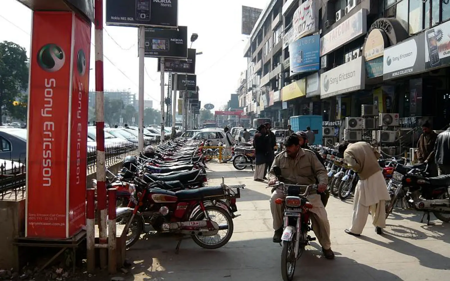 Motorbikes lined along a Lahore street