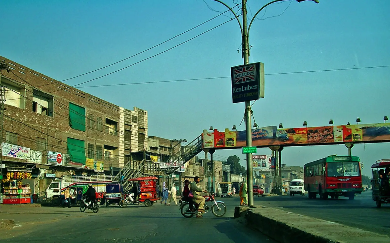 A Lahore street lined with shops and rickshaws