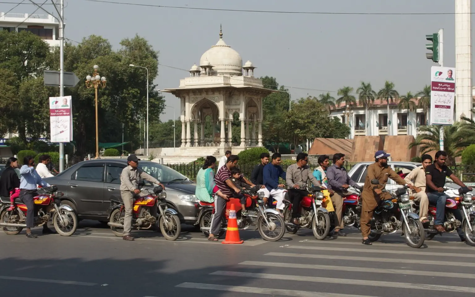 Motorbikes waiting at a junction by the Punjab Assembly, Lahore