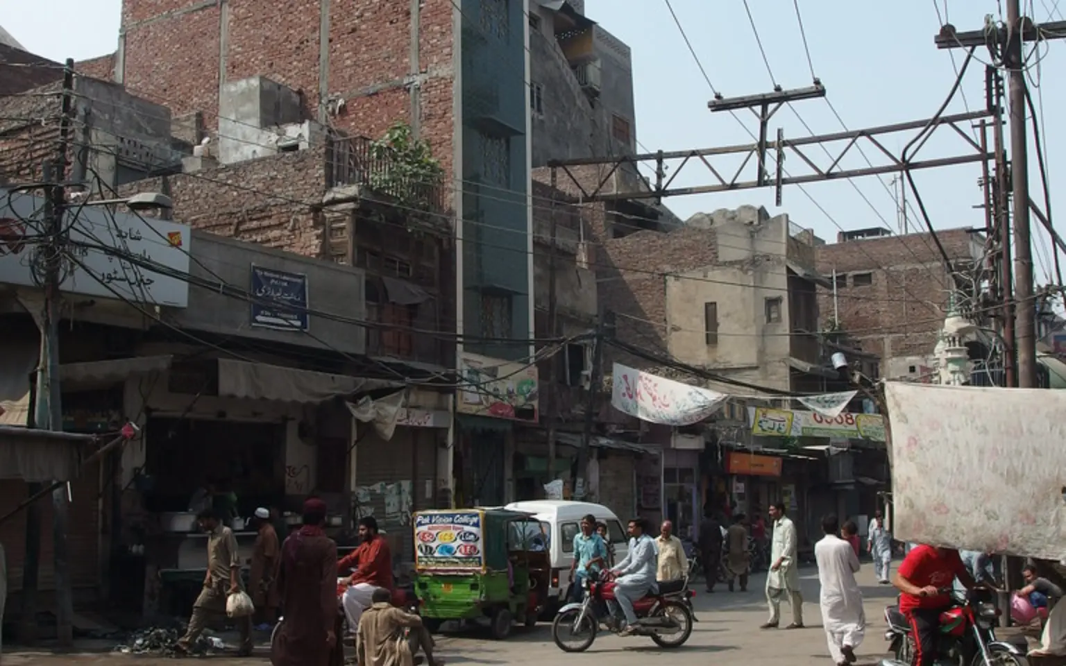 A narrow lane of shops and motorbikes inside Lahore's walled city