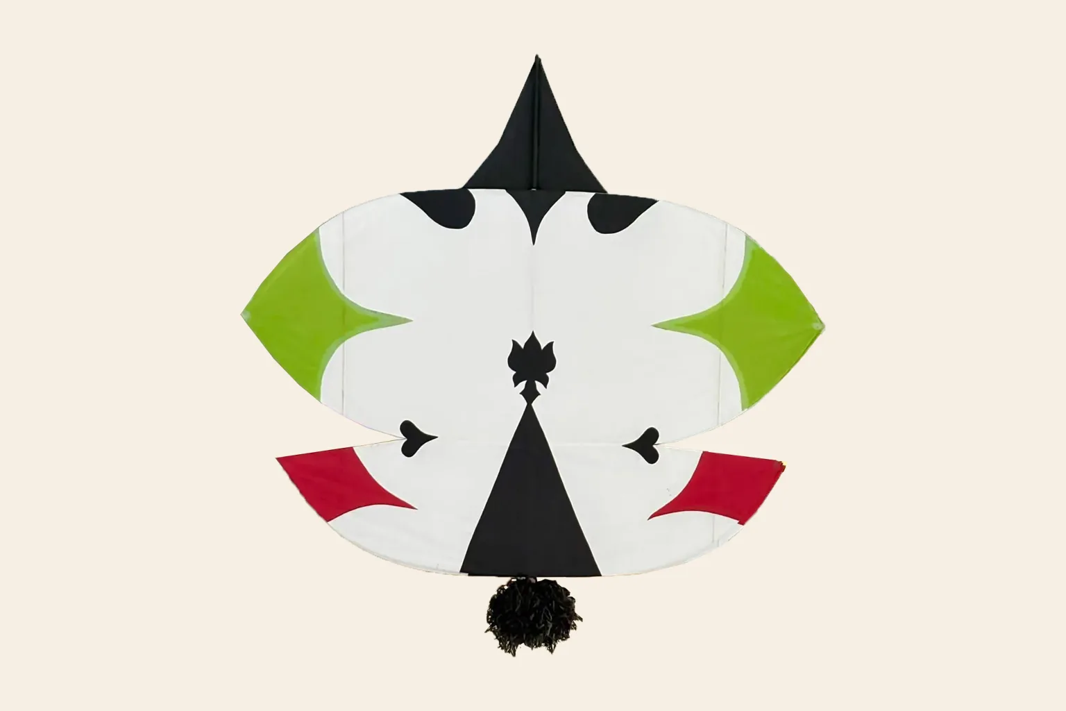 Large githi patang — white paper with black, green and red motifs and a tassel
